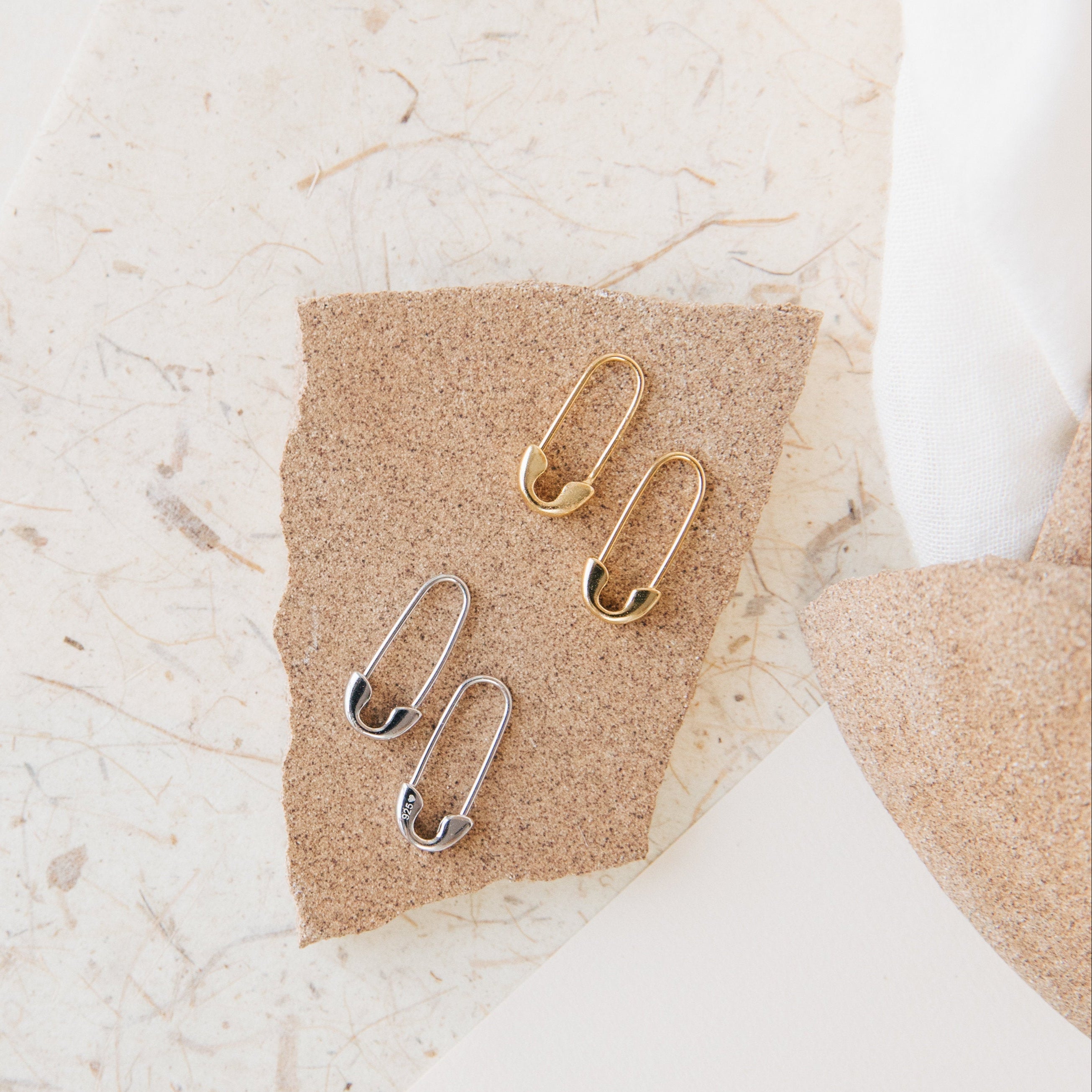 Ava Minimalist Safety Pin Earrings, featuring sterling silver or 18K gold with edgy glamour, perfect for adding a bold and eclectic touch to your style